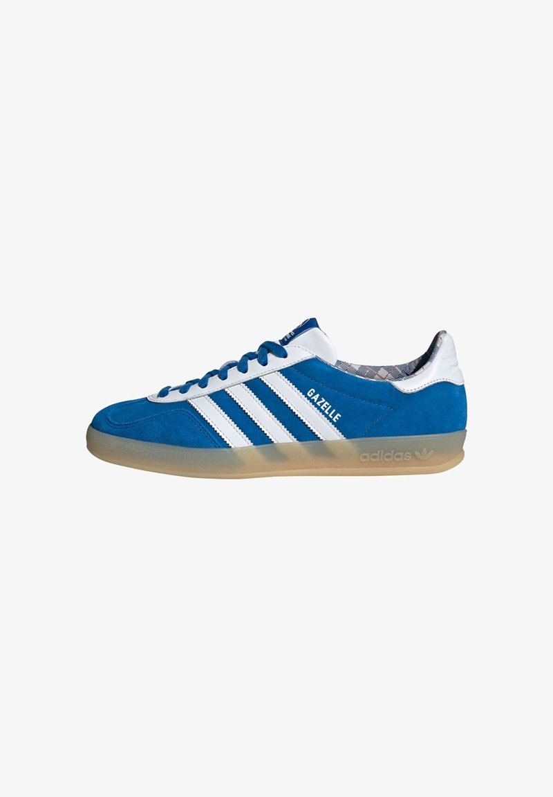 Baskets Adidas Gazelle bleu et blanc avec semelle en gomme et trois bandes blanches, vues de côté sur fond blanc.