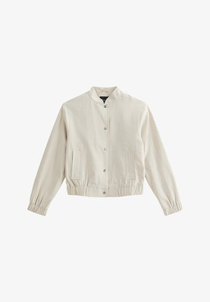 Light beige bomber jacket with a round collar, snap buttons, side pockets, and elastic cuffs; made from a smooth, textured fabric.