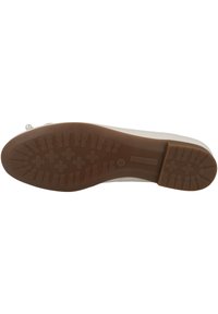 Semelle de chaussure avec une surface en caoutchouc brun texturé, présentant un motif géométrique pour l'adhérence et des points tridimensionnels pour une traction supplémentaire.
