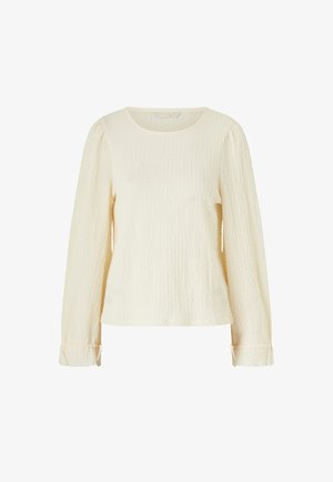 Long-sleeve ivory textured blouse with round neckline and subtle ruffle details at the sleeve cuffs.