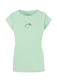 Lys grøn kortærmet t-shirt lavet af blødt stof, med et sort citron grafik trykt på forsiden. Rund halsudskæring, afslappet pasform.