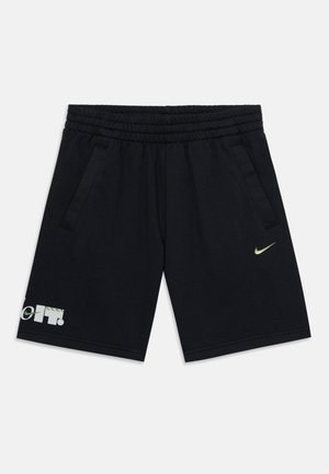 Sorte bomulds shorts med elastisk talje, to sidelommer og et grønt Nike-logo. Har et mønstret accent på venstre ben.