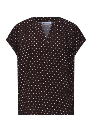 Blouse noire à manches courtes avec des pois blancs, col rond avec une petite découpe en V et coupe ample.