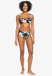 Black floral bikini featuring a square neckline top with wide straps and matching high-waisted bottom, adorned with colorful tropical patterns.