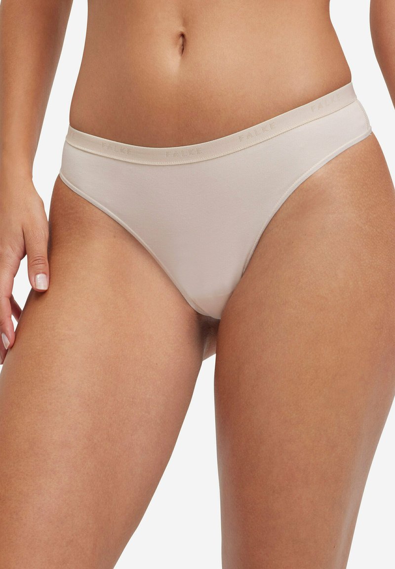 Perizoma in cotone beige dalla texture liscia, con fascia elastica in vita con il nome del marchio "FALKE" e design minimalista.