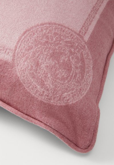 Pink felt cushion featuring a subtle embossed circular design and smooth texture, with rounded edges and contrasting stitching.