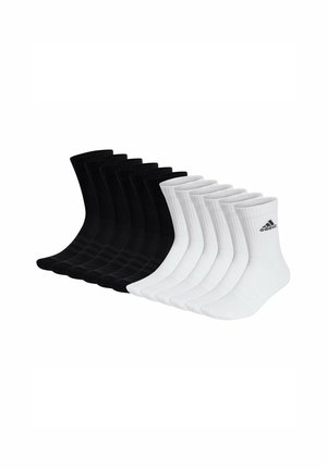 Nio par ankelsockar i svart och vitt, ribbad textur, med en Adidas-logotyp på sidan av varje vit par.