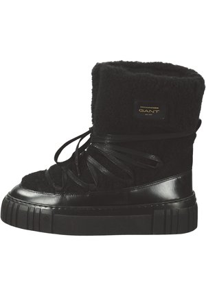 Black high-top boots made of textured wool and leather. Features a thick, ridged sole and black ribbon laces. Logo patch on the side.