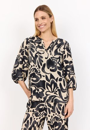 Blus med blommönster i beige och svart, med V-ringning och trekvartslånga ballongärmar, tillverkad av lättviktsmaterial.