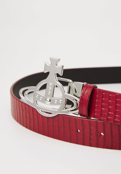 Red faux-crocodile leather belt with a shiny silver round buckle featuring a unique design and accents. Smooth texture and adjustable fit.