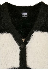 Svart och vit fluffig cardigan med knappstängning och ett strukturerat stickmönster, med en djup V-ringning och Urban Classics-märke invändigt.