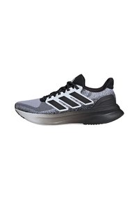 Running shoe in black, white, and gray with a textured mesh upper, sleek silhouette, three black stripes, and cushioned sole.