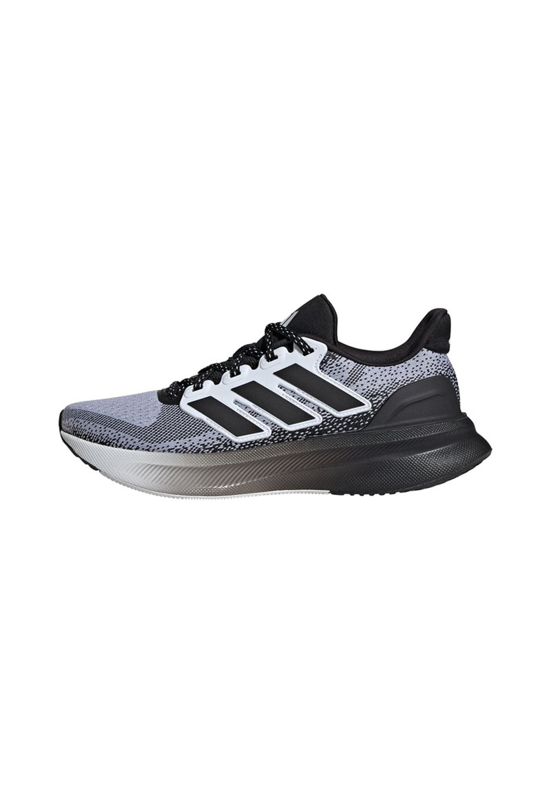Running shoe in black, white, and gray with a textured mesh upper, sleek silhouette, three black stripes, and cushioned sole.