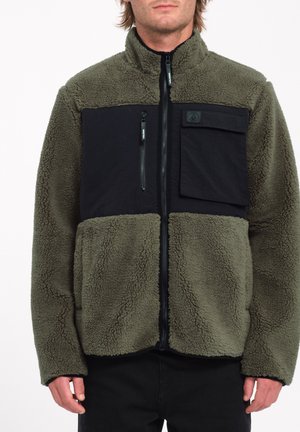 Fleecejack met een olijfgroene romp, zwart borstpaneel, ritszak en gestructureerde stof. Staande kraag en volledige ritssluiting.