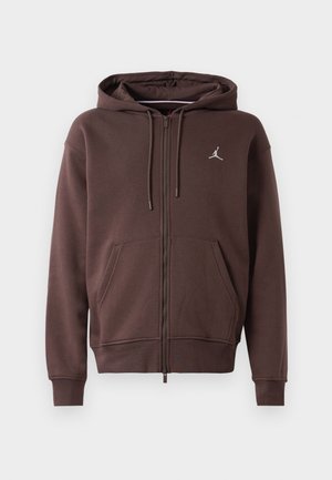 Brun zip-up hættetrøje med frontlommer, snoretræk i hætten og lille hvid Jordan-logo på brystet.
