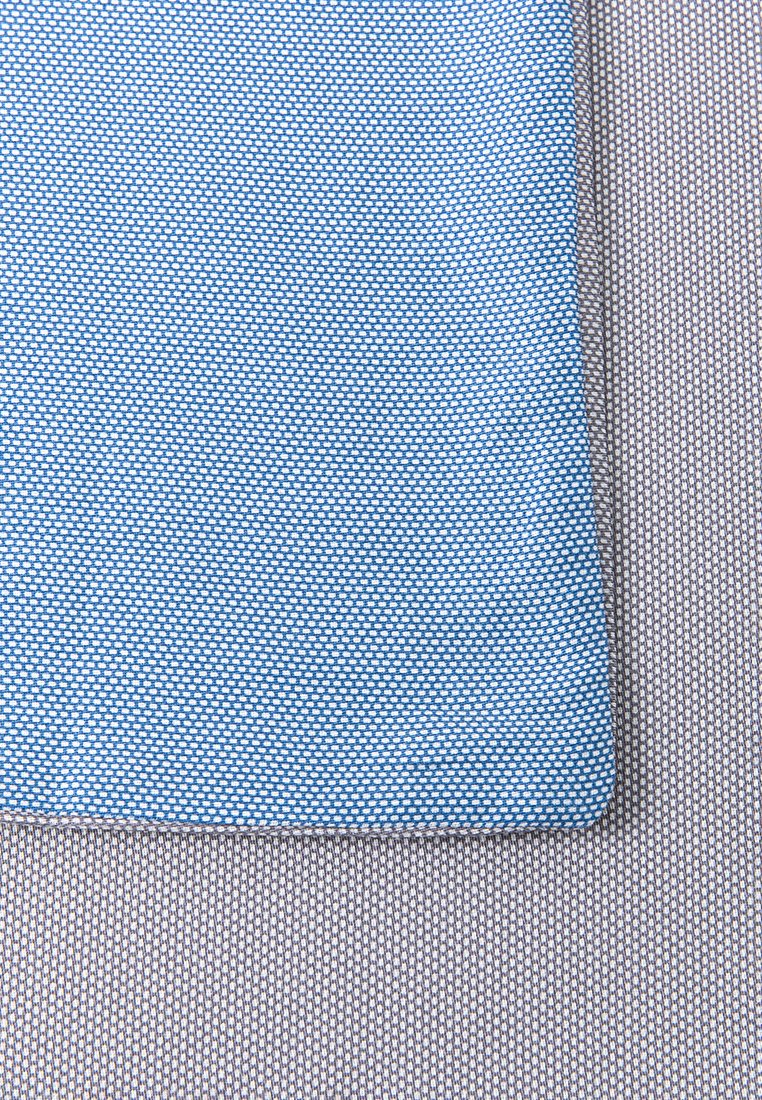 Textil-Patch in Blau mit einem strukturierten Muster, umrandet von einem feinen, karierten grauen Stoff, der ausgeprägte Farben und Texturen zeigt.