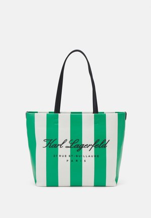 Tote bag with green and white vertical stripes, black handles, and "Karl Lagerfeld 21 Rue St-Guillaume Paris" text on the front.