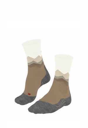 Chaussettes montant aux genoux en blanc, beige et gris avec un motif de montagne. Elles possèdent un bout et un talon gris rembourrés.