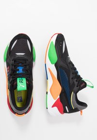 Black athletic shoes with mesh and synthetic materials, featuring multi-colored accents in red, green, blue, orange, and yellow.