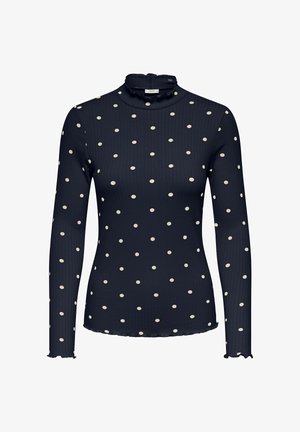 Granatowy top z długim rękawem i wysokim falbankowym kołnierzem. Posiada białe groszki, żebrowaną fakturę oraz faliste krawędzie na rękawach.