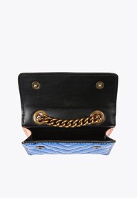 Compact wallet with a black textured interior and blue quilted exterior. Features a gold chain detail and orange accent on the side.