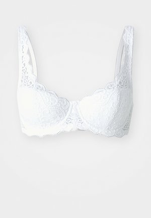 Hvid blonde bh med bølgede kanter, underwire støtte og brede stropper. Har intrikate blomster mønstre på kopperne og båndet.