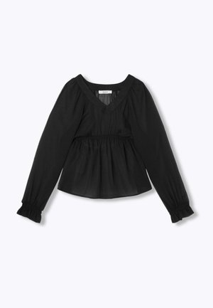 Blouse péplum noire avec manches longues froncées et encolure en V. Le tissu est léger et texturé avec un tombé subtil.