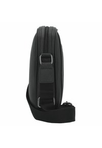 Black leather bag with a smooth texture, zippered closure, side hardware accents, and an adjustable black strap. Slim profile design.
