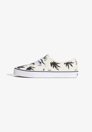 Low-top Vans sneaker with white base, black palm tree patterns, white laces, and thick white sole with black stripe.