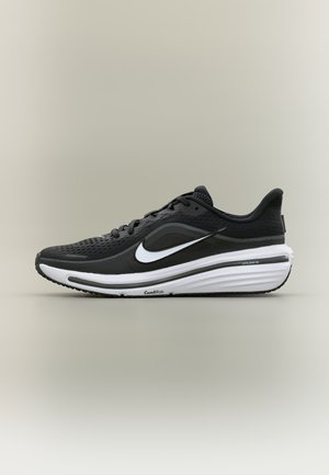 Fekete-fehér Nike futócipő szellőző felsőrésszel, vastag párnázott középtalppal, amelyen a "ComfiRide" felirat található, valamint jól látható fehér Nike logóval.
