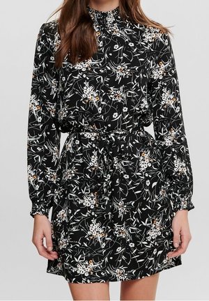Schwarzes Blumen Kleid mit langen Ärmeln, hohem Kragen und taillierter Taille. Verfügt über weiße und goldene Blumenmuster auf einem strukturierten Stoff.
