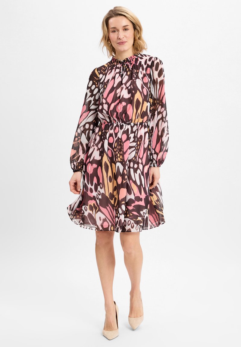 Langere jurk met een gatherede hals, elastische taille en een gedurfde, abstracte roze en bruine patroon op doorschijnende stof, afgewerkt met een zwierig zoom.