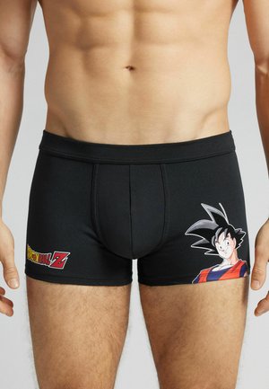 Boxer shorts noirs en tissu élastique avec un motif imprimé d'un personnage sur le côté gauche et un logo à l'avant.