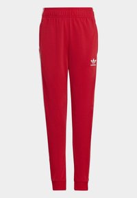 Rde športne hlače z elastičnim pasom, zoženimi nogami in belim logotipom Adidas na levem stegnu. Gladek, lahek material.