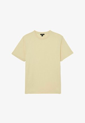 T-shirt girocollo a maniche corte di colore beige chiaro, taglia media, con etichetta del marchio nera all'interno del colletto.