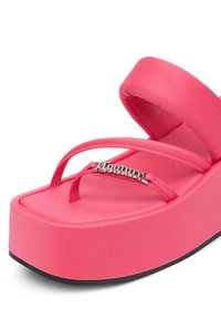 Pink platform sandal with thick sole and thin straps, featuring a silver decorative detail on the front strap.