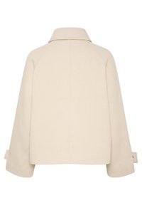 Beige cropped jakke med krave, rippet tekstur og brede ærmer. Har en lige kant med sidebånd til justering.