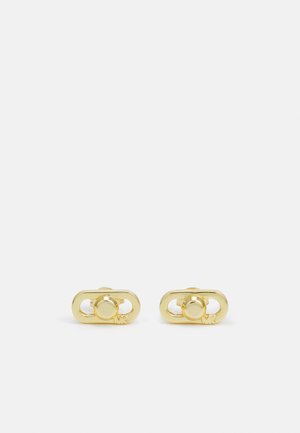 Orecchini in metallo color oro a forma ovale, con una sfera centrale e dettagli intagliati. Superficie liscia con finitura lucida.