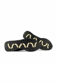 Scarpe sportive nere con suole in gomma beige curve. Le suole testurizzate presentano un motivo ondulato, progettato per offrire aderenza e supporto.
