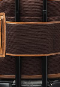 Brown textured suitcase back panel with two black retractable handles and leather trim detail.