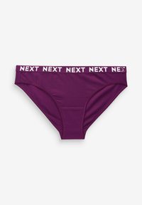 Lila bomba z bombažem z belim elastičnim pasom z logotipom "NEXT". Ima gladko teksturo in klasično zasnovo bombaža.