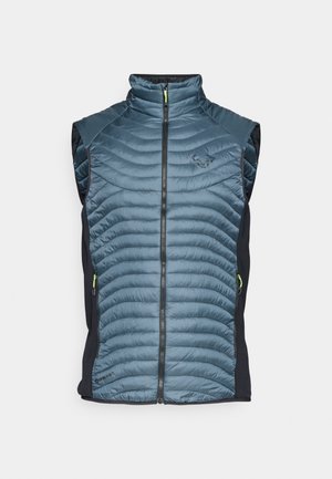 Polsterēta veste ar tumši zilu pārklātu priekšpusi, melniem sānu paneļiem, augstu apkakli, pilnu rāvējslēdzēju un ar rāvējslēdzēju slēdzamām kabatām ar zaļiem akcentiem.