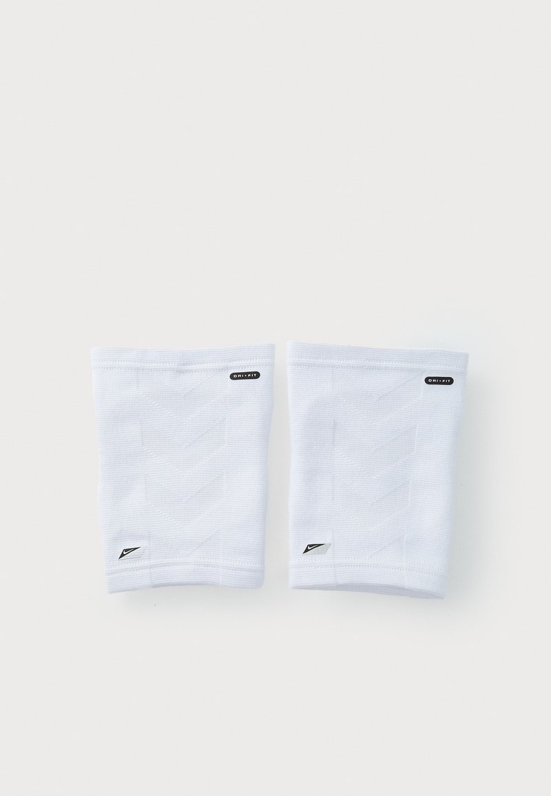 Witte sportmouwen van textiel met een gestructureerd patroon in chevron. Bevat een logo-label en een klein Nike-embleem aan de zijkant.