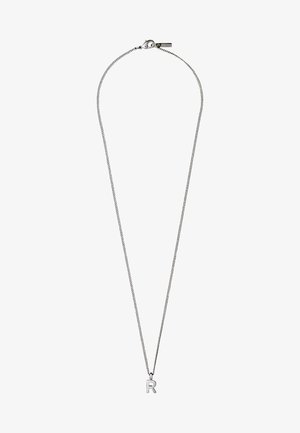Hõbedane kaelakee peene ahelaga ja väikese tähega "R" ripatsiga. Ahelal on vedru lukk ja minimalistlik disain.