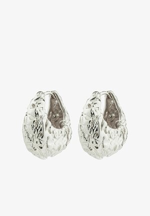 Silver metal hoop earrings with a textured surface, featuring an irregular, organic shape and a polished finish.