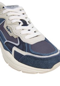 Navy and grey sneaker featuring mixed materials, including suede and fabric, with white laces and subtle logo detail on the side.