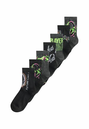Seven pairs of black and gray socks with gaming-themed designs including controllers, headsets, and text like "FUTURE PLAYER 1" and "PLAYER GAME".