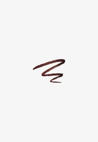 Trait de crayon eye-liner brun foncé en zigzag sur fond blanc.