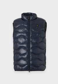 Μπλε σκούρο καπιτονέ αμάνικο γιλέκο τύπου puffer με ψηλό γιακά και εμπρόσθιο φερμουάρ, με μικρή μαύρη και κίτρινη ετικέτα μάρκας στο στήθος.