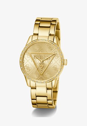 Relógio dourado com um mostrador texturizado apresentando o logótipo "GUESS" em relevo, rodeado por um bezel cravejado de cristais e uma bracelete de elos.